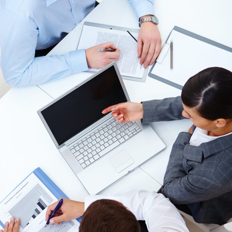 Above view of business partners working at meeting